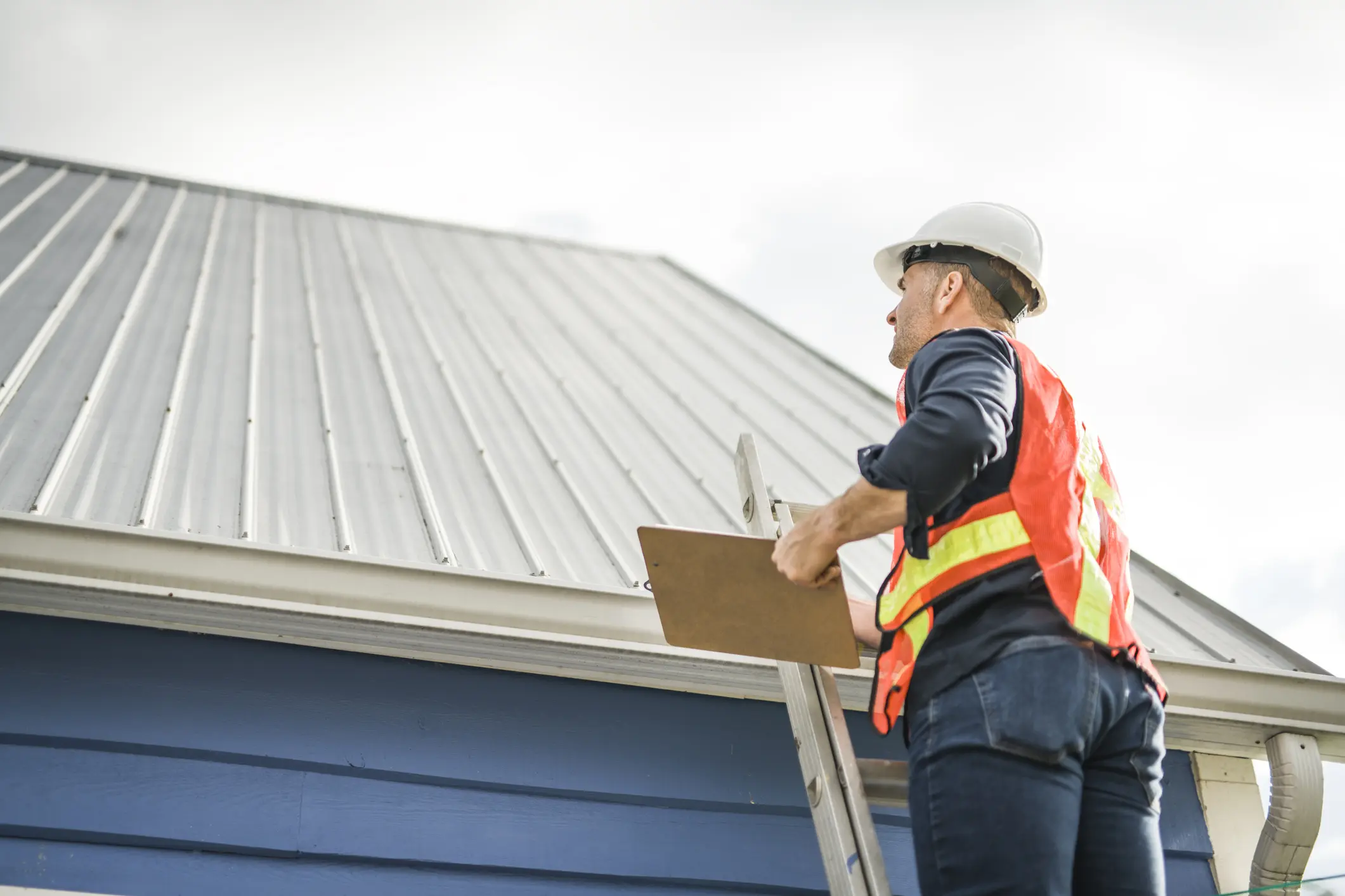 A man checking the roof for rooftop compliance certification.