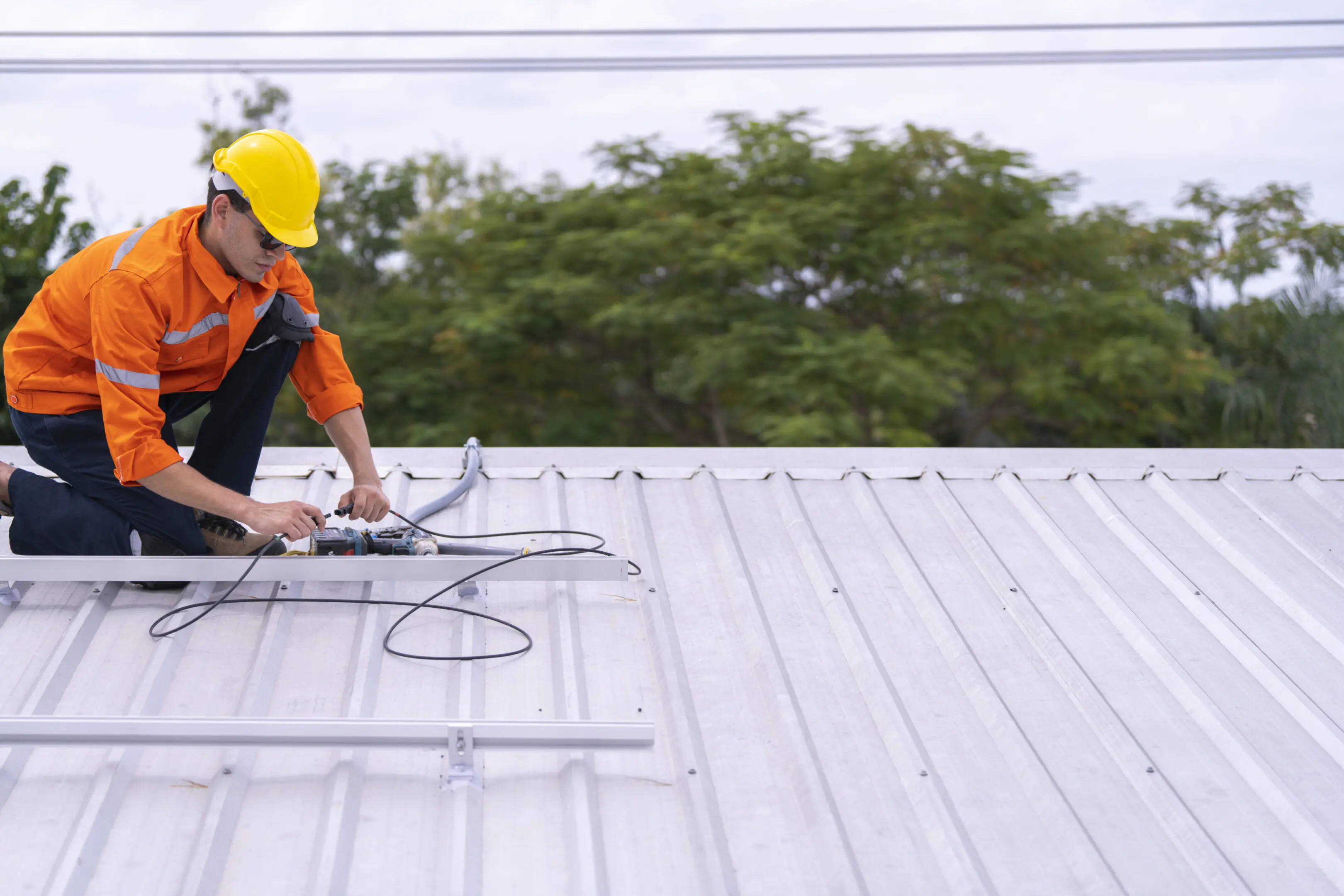 Technician securing rooftop solar equipment