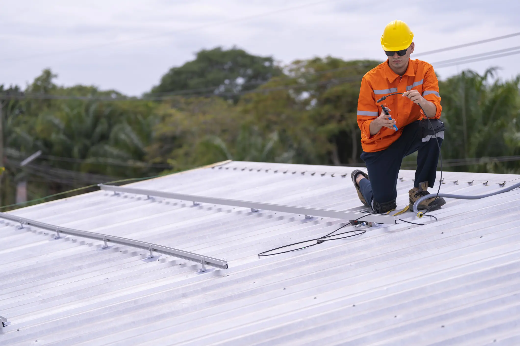 Construction worker on rooftop with tools